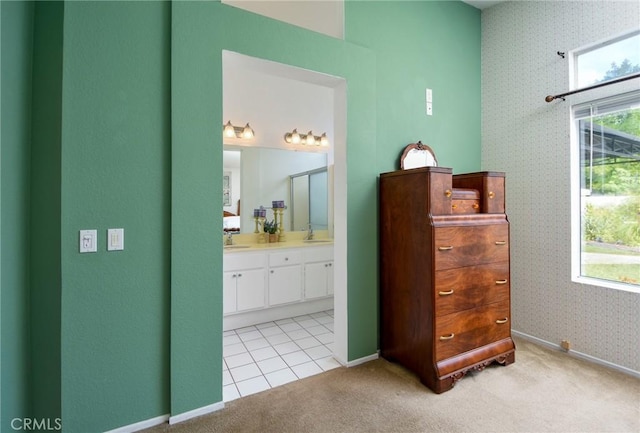 bathroom with vanity, baseboards, and wallpapered walls