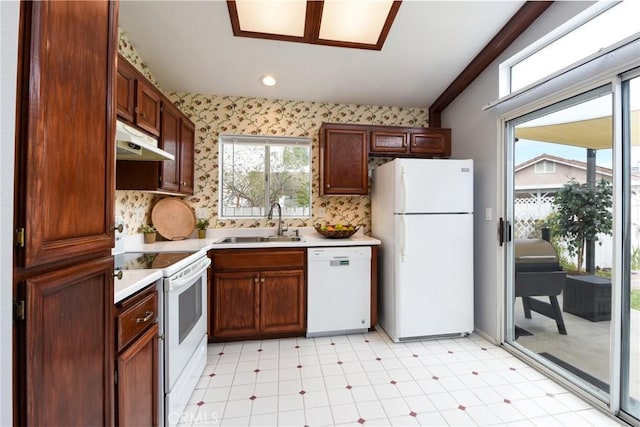 kitchen with white appliances, light floors, light countertops, under cabinet range hood, and a sink