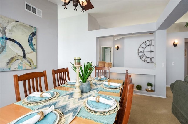 carpeted dining area featuring visible vents