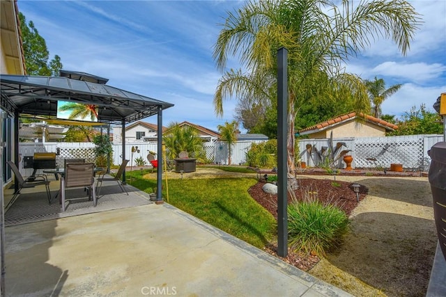 view of patio / terrace featuring a gazebo, outdoor dining space, and a fenced backyard