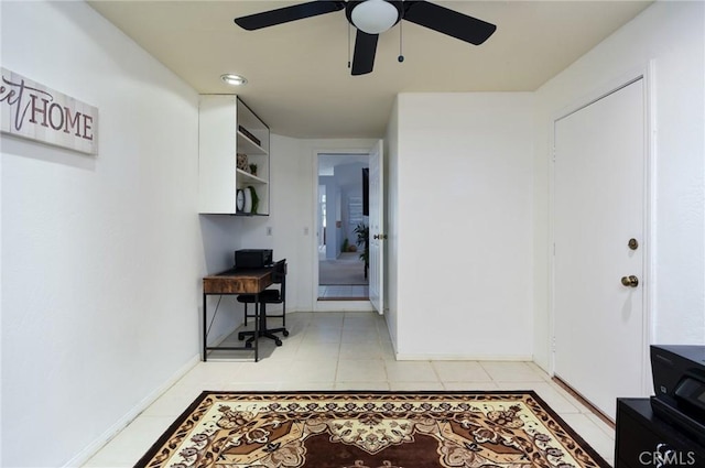 interior space with baseboards and light tile patterned floors