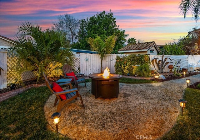 view of yard featuring an outdoor fire pit and a fenced backyard