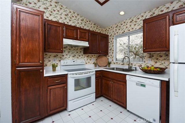 kitchen with white appliances, wallpapered walls, light countertops, under cabinet range hood, and a sink