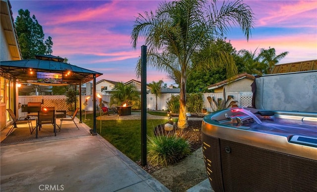 exterior space with a patio area, a fenced backyard, and a gazebo