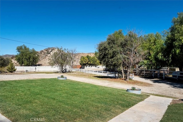 view of yard with fence and a mountain view