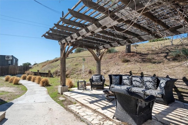 view of patio / terrace featuring outdoor lounge area, fence, and a pergola