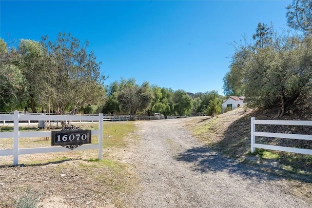 view of road featuring driveway and a rural view