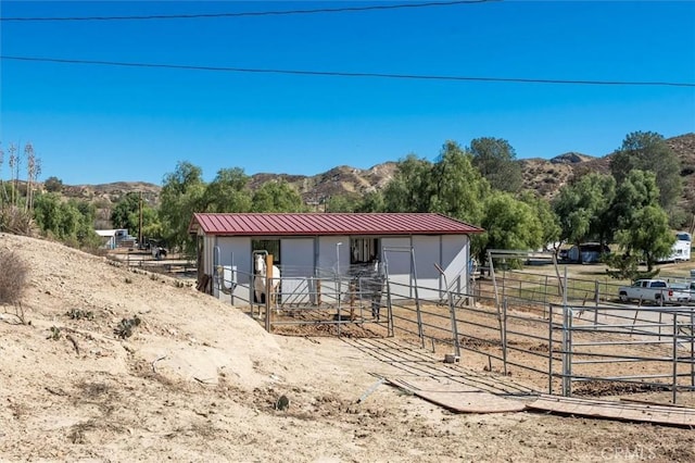 view of stable featuring a mountain view