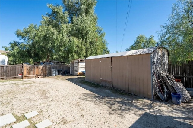 exterior space with a storage shed, an outdoor structure, and fence