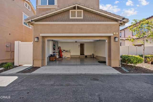 garage with driveway and fence