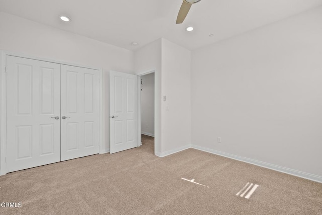 unfurnished bedroom featuring recessed lighting, a closet, carpet flooring, and baseboards