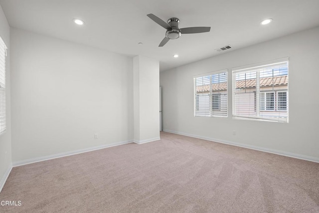 unfurnished room with light colored carpet, recessed lighting, a ceiling fan, baseboards, and visible vents