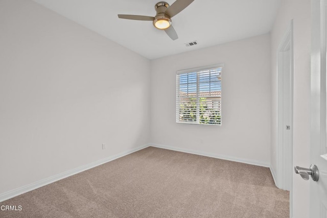 empty room featuring baseboards, a ceiling fan, visible vents, and light colored carpet