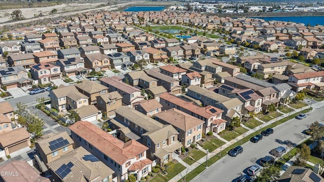 drone / aerial view featuring a water view and a residential view