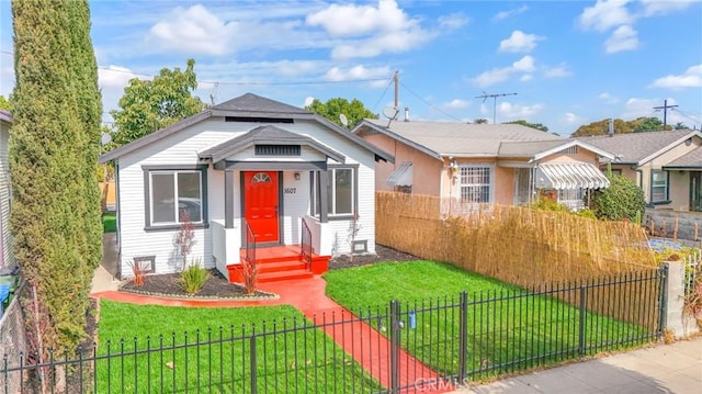 bungalow-style house with a fenced front yard and a front yard