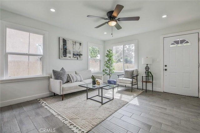 living room with wood tiled floor, baseboards, a ceiling fan, and recessed lighting