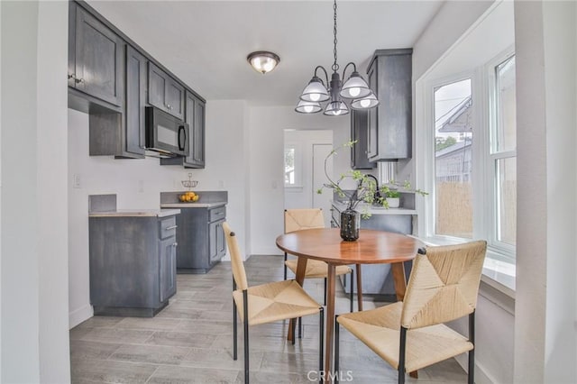 dining area with light wood-style flooring and baseboards