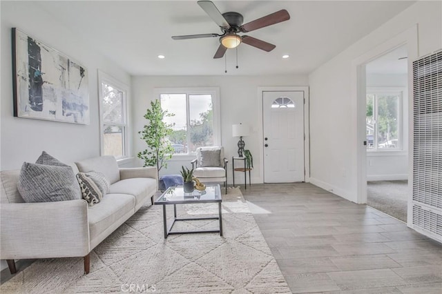 living area with a ceiling fan, baseboards, wood finished floors, and recessed lighting