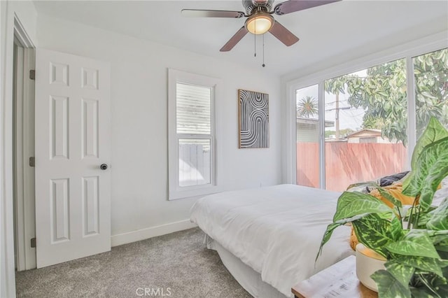 bedroom with carpet floors, baseboards, and a ceiling fan