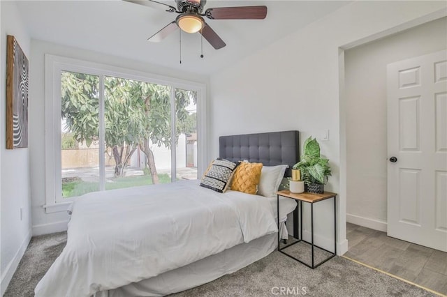 bedroom with ceiling fan, baseboards, and wood finished floors