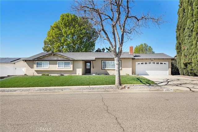 ranch-style house with a garage, concrete driveway, a chimney, a front yard, and stucco siding