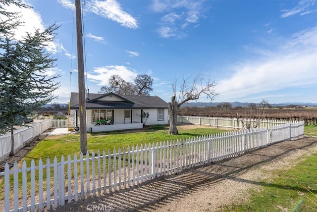 view of front facade with a fenced front yard and a front lawn