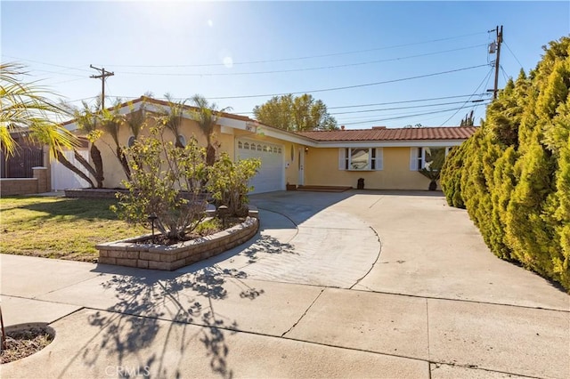 ranch-style house with driveway, an attached garage, a tile roof, and stucco siding