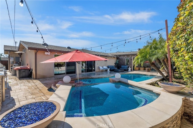 outdoor pool featuring a patio and an outdoor living space