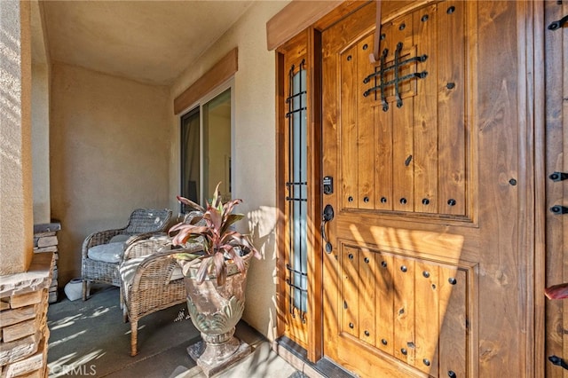 entrance to property featuring stucco siding