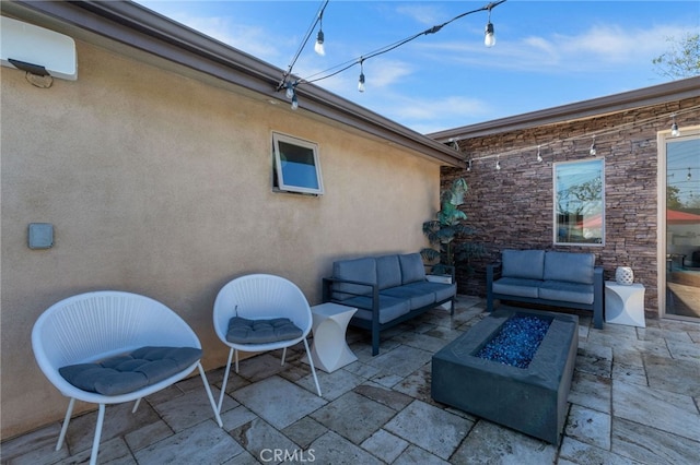 view of patio / terrace featuring an outdoor living space with a fire pit