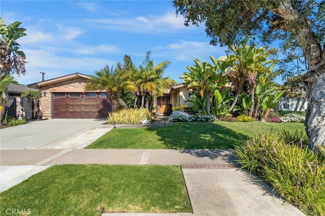 view of property hidden behind natural elements with stone siding, an attached garage, driveway, and a front lawn