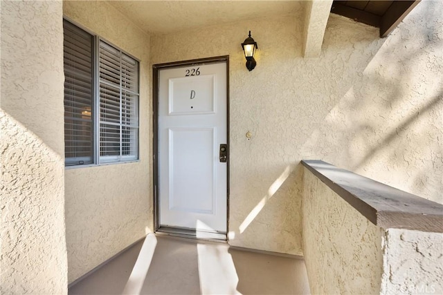 property entrance featuring stucco siding