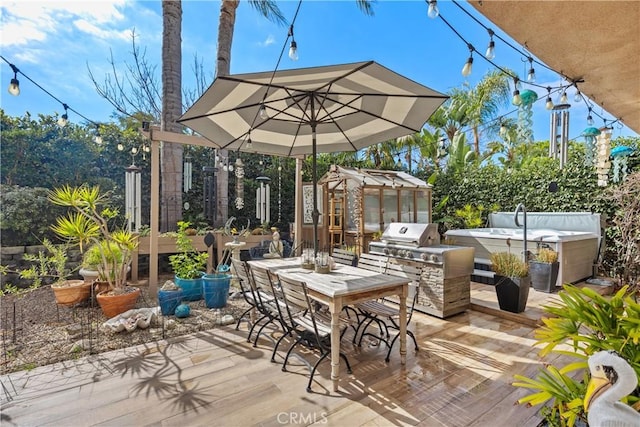 deck with outdoor dining area, an exterior structure, an outdoor kitchen, a grill, and an outdoor structure