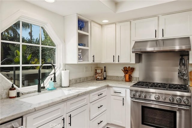 kitchen featuring under cabinet range hood, stainless steel appliances, a sink, white cabinetry, and open shelves