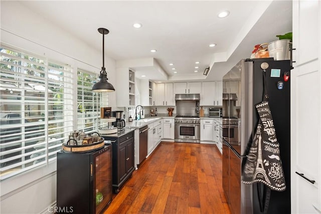 kitchen with appliances with stainless steel finishes, dark wood-style flooring, under cabinet range hood, open shelves, and recessed lighting