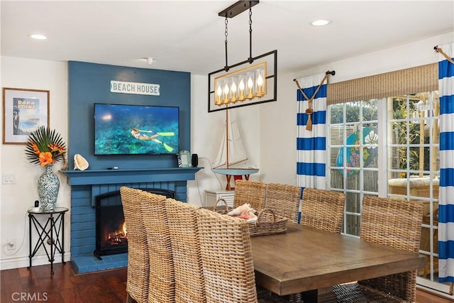 dining space featuring a fireplace, baseboards, wood finished floors, and recessed lighting