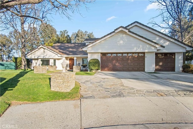 single story home featuring concrete driveway, an attached garage, and a front yard