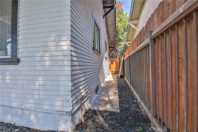 view of side of property featuring fence