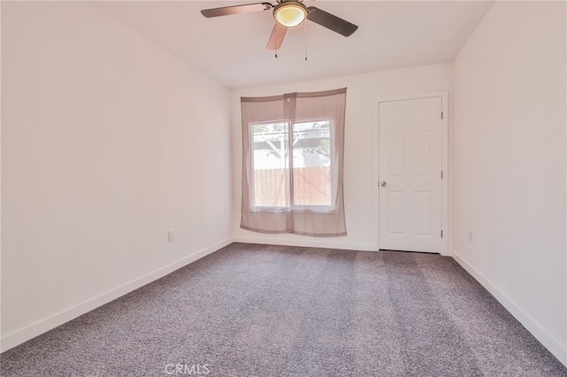 empty room with a ceiling fan, carpet, and baseboards