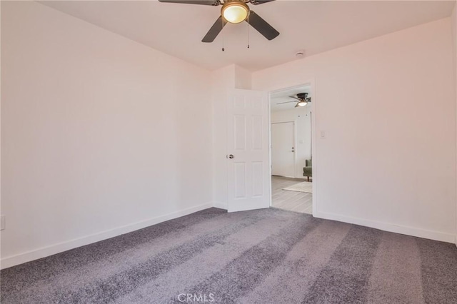 spare room featuring carpet flooring and baseboards