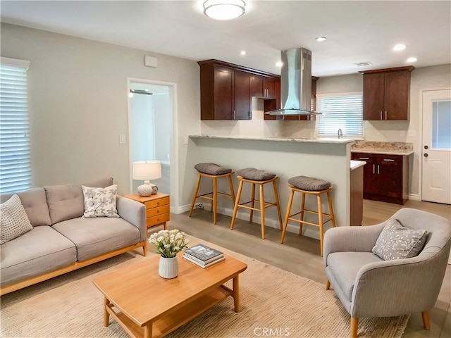 living room with baseboards and recessed lighting