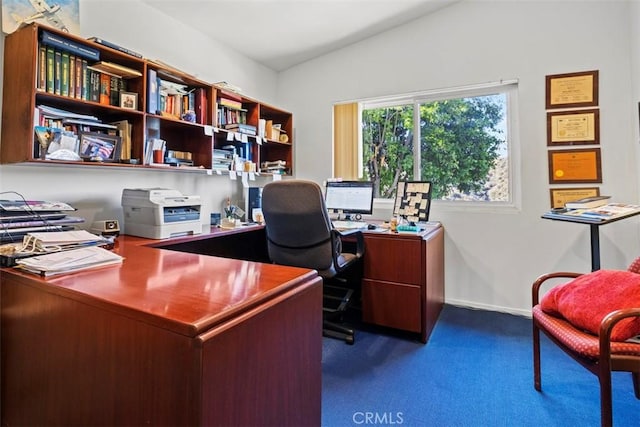 office area with lofted ceiling, baseboards, and dark colored carpet