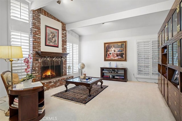 carpeted living area with a fireplace and beamed ceiling