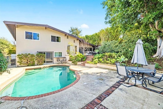 pool featuring fence and a patio