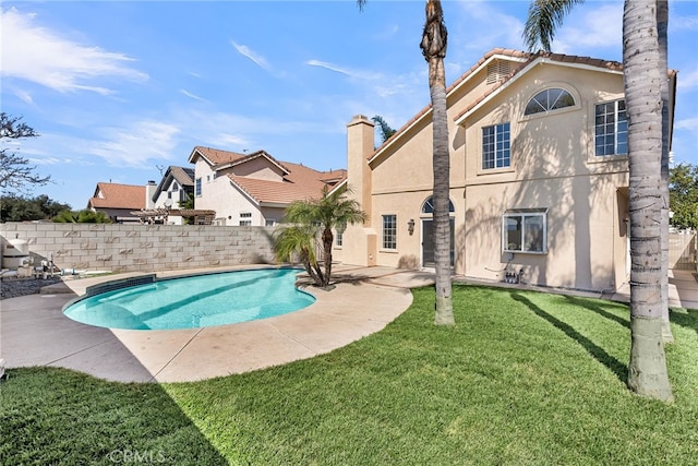 view of pool with a fenced in pool, a fenced backyard, a lawn, and a patio