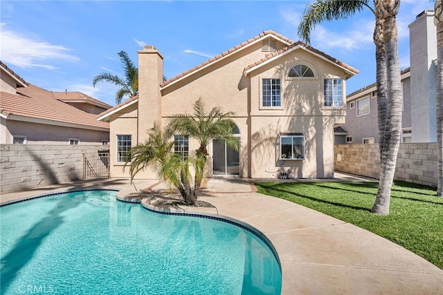 view of swimming pool featuring a patio area, fence, a fenced in pool, and a yard