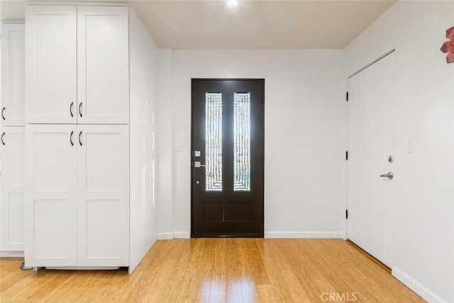 entrance foyer with baseboards and light wood-style floors