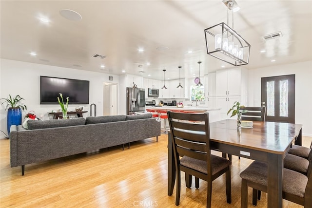 dining area with visible vents, recessed lighting, and light wood-type flooring