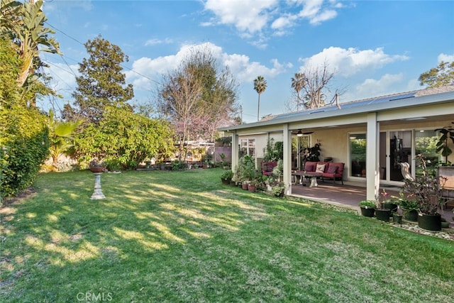 view of yard featuring a patio and ceiling fan