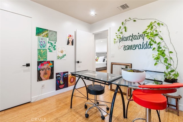 interior space with visible vents, baseboards, and wood finished floors